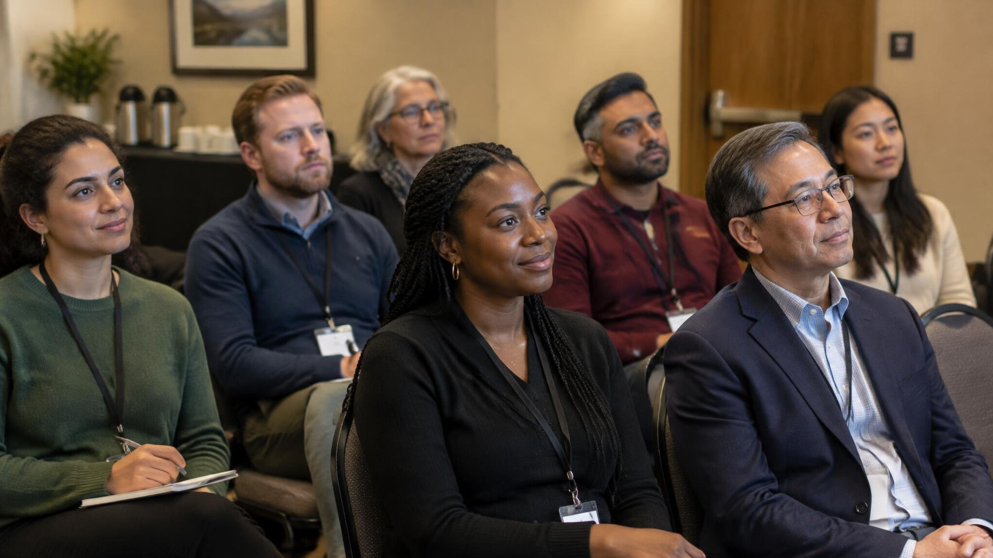 Small audience listening to a speaker during a cultural conference